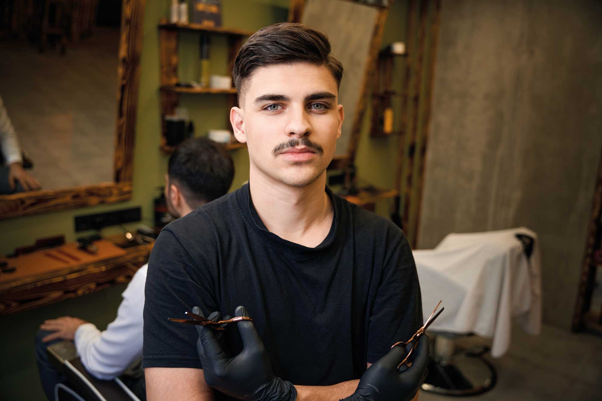 hairdresser-holding-scissors-in-barbershop-2024-04-08-19-25-52-utc